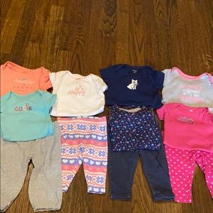 7 Adorable onesies and 4 pants.